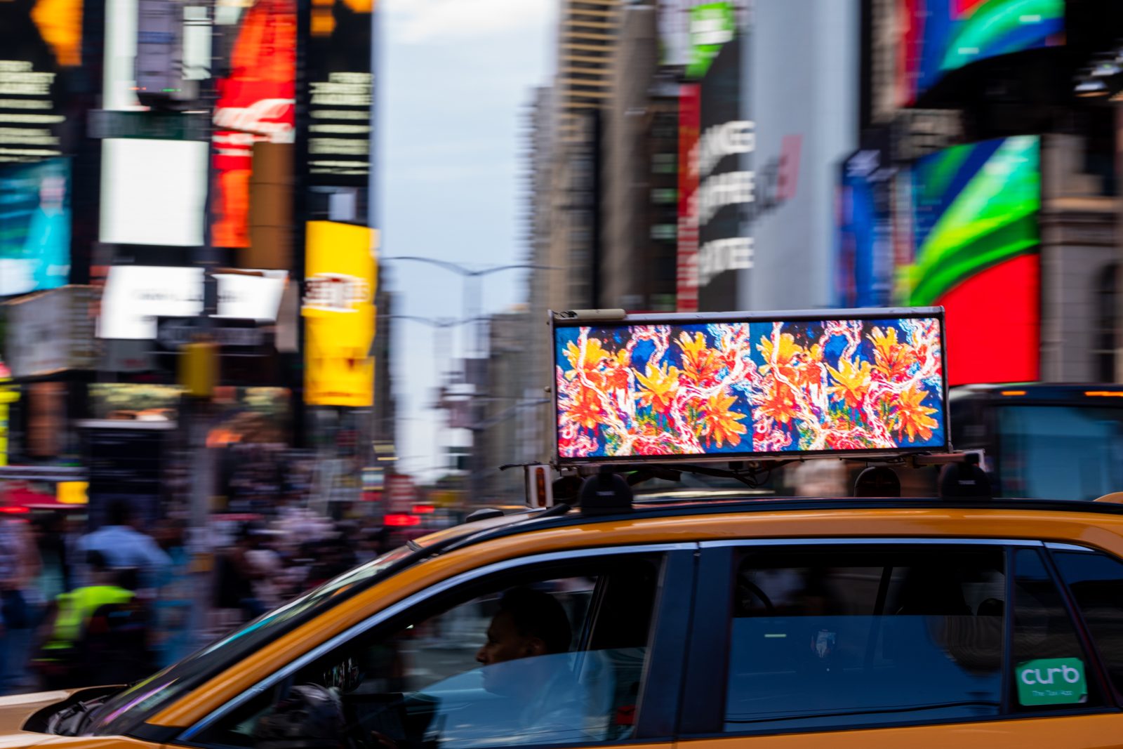 MLow's The Evolution of fLOWers on a taxi top screen in Times Square, New York